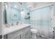 Light blue bathroom with a shower/tub combo and gray vanity at 8251 Brent St # 912, Port Richey, FL 34668