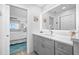 Updated bathroom with gray vanity, quartz countertop, and a large mirror at 8251 Brent St # 912, Port Richey, FL 34668