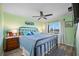 King-size bedroom with light green walls and a ceiling fan at 8251 Brent St # 912, Port Richey, FL 34668