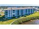 Waterfront building with balconies and lush landscaping at 8251 Brent St # 912, Port Richey, FL 34668