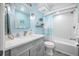 Light blue bathroom with a shower/tub combo and gray vanity at 8251 Brent St # 912, Port Richey, FL 34668
