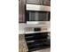 Stainless steel range and microwave in modern kitchen at 12950 Fennway Ridge Dr, Riverview, FL 33579