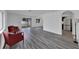Spacious living room with gray vinyl plank floors and two red armchairs at 12950 Fennway Ridge Dr, Riverview, FL 33579