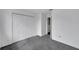 Empty bedroom with grey carpet and double doors at 12950 Fennway Ridge Dr, Riverview, FL 33579