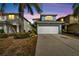 Two-story house with a white garage door and light blue exterior at 12950 Fennway Ridge Dr, Riverview, FL 33579