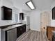 Modern kitchen with dark brown cabinets, granite countertops, and stainless steel appliances at 12950 Fennway Ridge Dr, Riverview, FL 33579