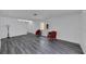 Bright living room with gray vinyl flooring and two red accent chairs at 12950 Fennway Ridge Dr, Riverview, FL 33579