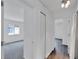 Bright hallway with doors to bedrooms and wood floors at 12950 Fennway Ridge Dr, Riverview, FL 33579