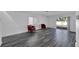Spacious living room featuring gray vinyl flooring and sliding glass doors to backyard at 12950 Fennway Ridge Dr, Riverview, FL 33579