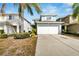 Two-story house with light blue exterior, white garage door, and landscaping at 12950 Fennway Ridge Dr, Riverview, FL 33579
