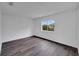 Bedroom with dark grey wood flooring and a window at 12950 Fennway Ridge Dr, Riverview, FL 33579