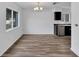 Simple dining area with gray vinyl flooring and a view to the kitchen at 12950 Fennway Ridge Dr, Riverview, FL 33579