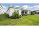 Beautiful backyard with a covered patio, lush lawn, and a glimpse of a screened-in pool at 17721 Roost Pl, Lakewood Ranch, FL 34211