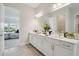 Bathroom featuring double vanity with white cabinets and luxurious finishes at 17721 Roost Pl, Lakewood Ranch, FL 34211