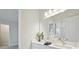 Bright bathroom featuring a dual sink vanity with modern fixtures and quartz countertops at 17721 Roost Pl, Lakewood Ranch, FL 34211