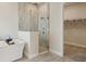 Modern shower with glass enclosure, and adjacent walk-in closet in the bathroom at 17721 Roost Pl, Lakewood Ranch, FL 34211