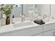 Bright bathroom featuring a dual sink vanity with modern fixtures and quartz countertops at 17721 Roost Pl, Lakewood Ranch, FL 34211