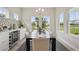 Bright dining room with modern chandelier, lake view, and wine storage at 17721 Roost Pl, Lakewood Ranch, FL 34211