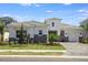 Beautiful single-Gathering home featuring stone accents, a tile roof, and an attached two-car garage on a perfectly manicured lot at 17721 Roost Pl, Lakewood Ranch, FL 34211