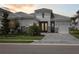 Beautiful exterior showcasing its landscaped grounds and double door entry at 17721 Roost Pl, Lakewood Ranch, FL 34211