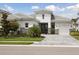 Stunning home exterior with a stone facade, double doors, and a spacious three-car garage at 17721 Roost Pl, Lakewood Ranch, FL 34211