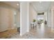 Hallway with tile floors, white walls, and access to other rooms, creating a bright and inviting space at 17721 Roost Pl, Lakewood Ranch, FL 34211