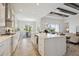 Modern kitchen featuring white cabinetry, stainless steel appliances, and a spacious island for meal preparation and dining at 17721 Roost Pl, Lakewood Ranch, FL 34211