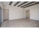 Living room with high ceilings, exposed beams and sliding doors to lanai at 17721 Roost Pl, Lakewood Ranch, FL 34211