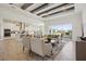 Open concept living room showcasing elegant furniture, wood-look tile floors, and a beautiful view of the backyard at 17721 Roost Pl, Lakewood Ranch, FL 34211