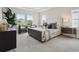 Spacious main bedroom featuring tray ceilings, a sitting area, and view of outdoors at 17721 Roost Pl, Lakewood Ranch, FL 34211