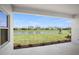 Stunning water view from the covered lanai overlooking the lush landscaping and neighborhood in this new construction home at 17721 Roost Pl, Lakewood Ranch, FL 34211