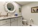 Charming bathroom featuring a decorative mirror, marble countertop, and stylish fixtures at 12246 2Nd E St # 503, Treasure Island, FL 33706