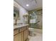 Neutral bathroom with gold hardware, marble countertops and glass enclosed tub/shower at 12246 2Nd E St # 503, Treasure Island, FL 33706