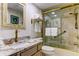 Neat bathroom with gold hardware, neutral stone and a glass enclosed tub/shower at 12246 2Nd E St # 503, Treasure Island, FL 33706