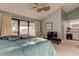 Cozy bedroom with vaulted ceilings, en-suite bathroom, and sliding glass doors to a balcony at 12246 2Nd E St # 503, Treasure Island, FL 33706