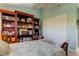 Bright bedroom featuring a bed and dark wood bookshelves filled with decorations and photos at 12246 2Nd E St # 503, Treasure Island, FL 33706