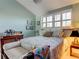 Cozy bedroom with a full bed and bench and shuttered window at 12246 2Nd E St # 503, Treasure Island, FL 33706