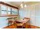 A charming breakfast nook features a wooden table, shuttered windows, and stylish terra cotta flooring at 12246 2Nd E St # 503, Treasure Island, FL 33706