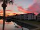 Waterfront condos at sunset with red sky reflections and palm trees at 12246 2Nd E St # 503, Treasure Island, FL 33706
