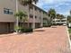 Condo complex with brick driveway, carports, and landscaped gardens at 12246 2Nd E St # 503, Treasure Island, FL 33706