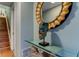 Stylish hallway decor features a golden sunburst mirror and a decorative statue on a glass-topped table at 12246 2Nd E St # 503, Treasure Island, FL 33706