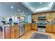 Open kitchen featuring stainless steel appliances, breakfast bar, and tile flooring at 12246 2Nd E St # 503, Treasure Island, FL 33706