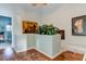 The landing features hardwood floors, a zebra rug, decor, and artwork, adding character to this home's design at 12246 2Nd E St # 503, Treasure Island, FL 33706