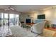 Bright living room with a ceiling fan, fireplace, and sliding glass doors to the balcony at 12246 2Nd E St # 503, Treasure Island, FL 33706
