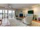 Cozy living room boasting waterfront views, fireplace, comfortable seating, and terra cotta tile flooring at 12246 2Nd E St # 503, Treasure Island, FL 33706