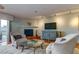Cozy living room with comfortable chairs, a fireplace, and a balcony overlooking the water at 12246 2Nd E St # 503, Treasure Island, FL 33706