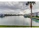 Enjoy serene water views of the channel from the property, complemented by lush palm trees and clear skies at 12246 2Nd E St # 503, Treasure Island, FL 33706