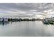 Scenic waterfront view showcasing the tranquil canal lined with homes and docked boats under a cloudy sky at 12246 2Nd E St # 503, Treasure Island, FL 33706