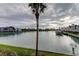 Scenic waterfront view featuring calm waters, lush greenery and mature palm trees at 12246 2Nd E St # 503, Treasure Island, FL 33706