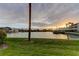 Scenic waterfront view featuring calm waters, lush greenery, and a glimpse of the sunset at 12246 2Nd E St # 503, Treasure Island, FL 33706